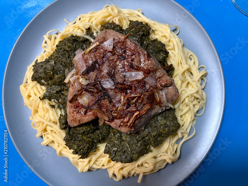 Veal liver with shallots on a bed of Taglionelli and spinach