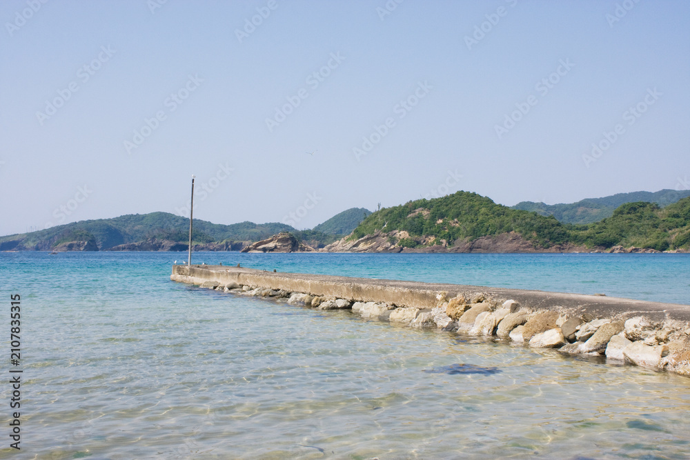 Fototapeta premium Concrete Pier on Crystal Clear Sea near a Fishing Harbor in Shimane Japan