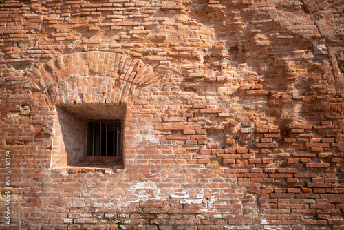 Cuadro en lienzo A window and rusty bars an ancient prison red brick structure wall