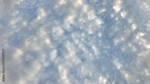 Timelapse video looking directly up at blue sky with white clouds drifting fast