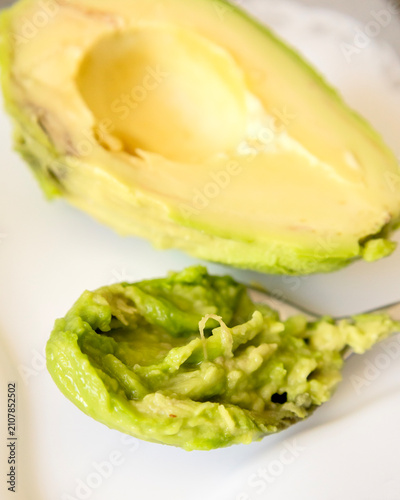 Spoon with Creamy Avocado Puree Mash Close Up