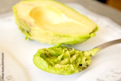 Spoon with Creamy Avocado Puree Mash Close Up