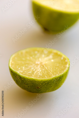 Juicy Raw Lime Cut in Half with Citrus Texture on Pure White Background