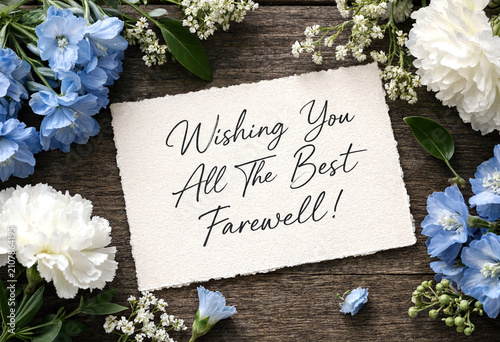 Beautiful farewell card surrounded by delicate white and blue flowers on rustic wooden background