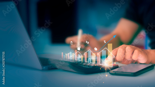 Businessman calculating property value growth and interest rates with virtual interface.