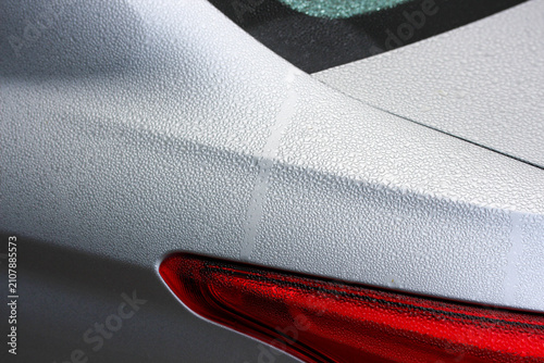 Close up of morning dew on a silver car