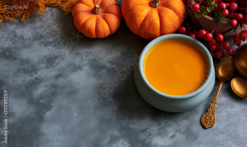 Pumpkin soup on autumn rustic topview background 