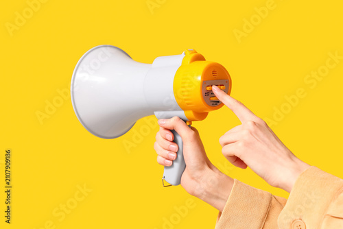 Woman turning on megaphone ...