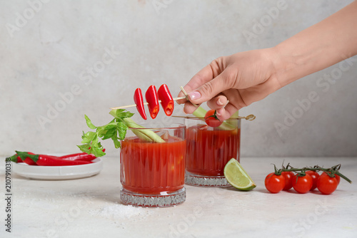 Female hand with cut chili ...