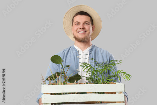 Young male gardener holding...