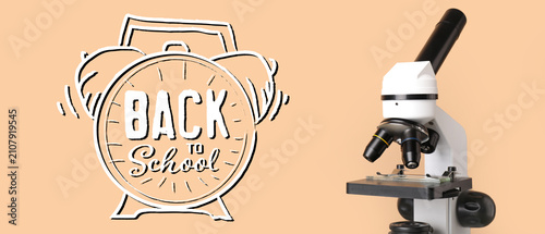 Foto Back to school alarm clock illustration with a white microscope on a peach backg