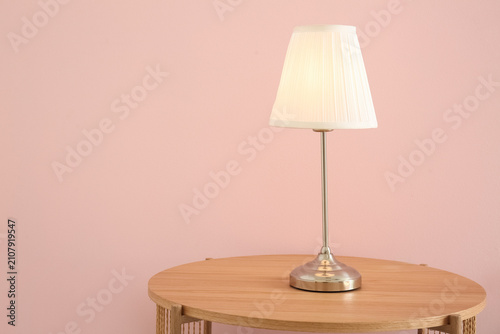 Glowing lamp on wooden tabl...