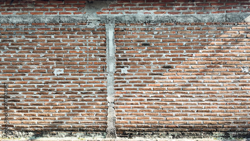 Close-up view of an aging brick wall with intricate textures and colors showcasing the passage of time