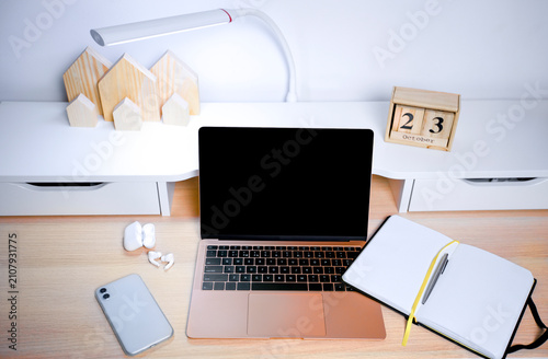 Modern Home Office Desk Setup with Laptop and Notebook