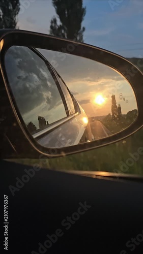 Road Reflected in Car Rearview Mirror During Golden Sunset Drive