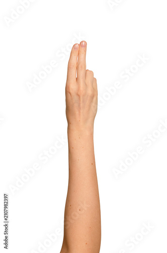 Index and middle fingers raised in a peace-like gesture. Woman s hand showing two extended fingers