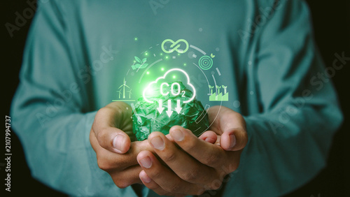 commitment, increase, responsibility, planet,Hands holding a green paper globe with CO₂ reduction interface highlighting net zero goals, renewable energy and sustainable environmental practices.