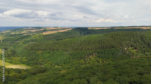 Moselle valley landscape, grassland and forest, summer meadow with flowers, wind turbines on mountain, rhineland palatinate, Germany, aerial view