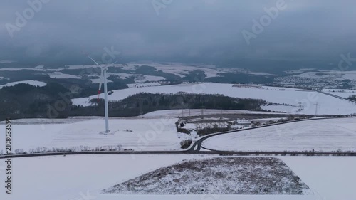 Wind turbine and solar panel in snow, dark doldrums or wind lull in winter, no renewable sustainable energy, environmental conversation