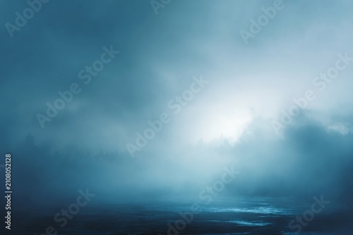 Atmospheric image features a tranquil and mysterious blue landscape with mist and water. Use for creative projects, backgrounds, or to evoke a sense of calm and wonder. Ideal for artistic expression.