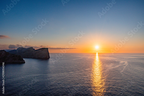 Foto Golden sunset over Cap de Formentor cliffs with sun reflection on calm Mediterranean Sea in Mallorca, Balearic Islands, Spain