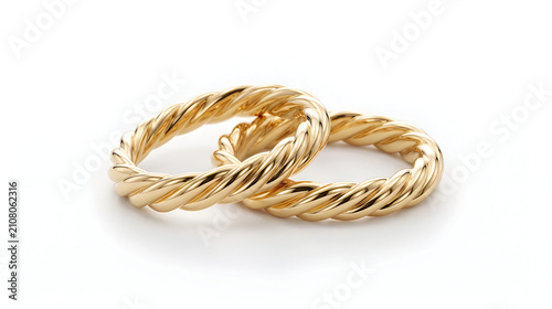 Pair of twisted golden wedding rings isolated on white background symbol of love and eternal union