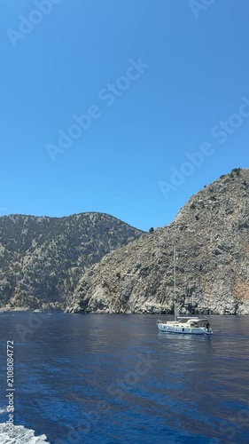 Deep blue Mediterranean sea stretching to the horizon, crystal-clear water, gentle ripples, bright sunshine, peaceful coastal landscape