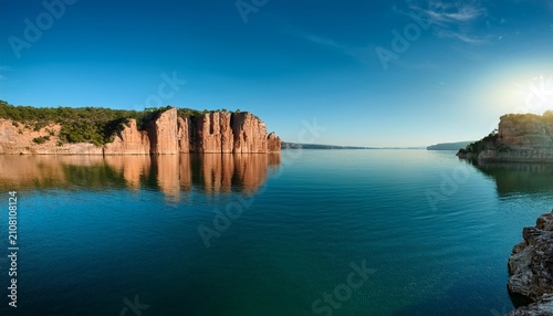 Serene Landscape Of Rocky Cliffs And Calm Waters A Tranquil Escape Into Nature S Beauty