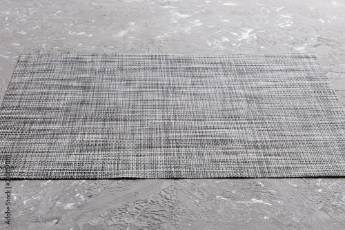 Perspective view of grey tablecloth for food on cement background. Empty space for your design