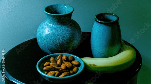 nightstand. A few almonds and a banana on a nightstand in cool blue moonlight. menu design, packaging mockups, designed for culinary blogs and recipe cards for restaurants, used by sports marketers.