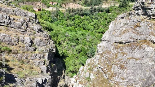 Reverse Drone Flight Revealing a Rocky Canyon River in Portugal