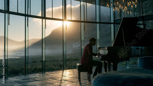 Pianist Playing Grand Piano with Mountain Landscape View