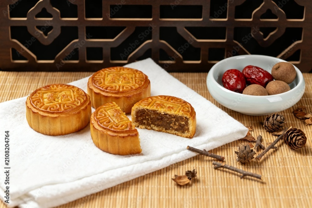 Fototapeta premium Mooncakes with Jujube and Longan on Rustic Table