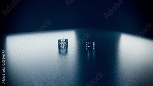Gravity pulling two glass cubes falling and rotating onto textured table, forming light reflections