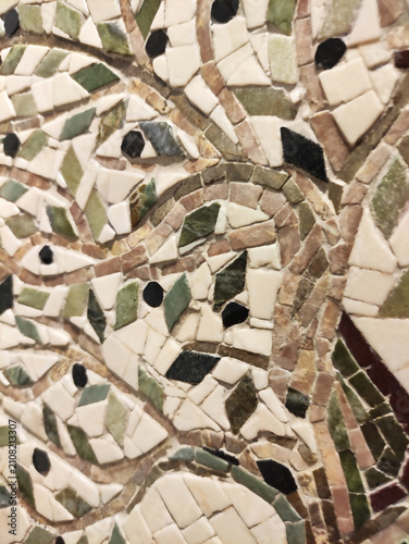 Close-up of a colorful mosaic made of ceramic fragments. Abstract texture, decorative art, handmade craftsmanship, detailed mosaic pattern.