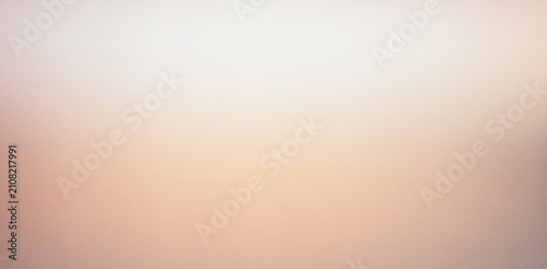 Abstract smooth pale peach and light brown elegant grainy gradient background