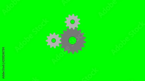Three interlocking gears rotating on a green screen background, representing teamwork and mechanical processes.