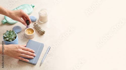 Hands organizing self-care essentials for wellness and relaxation