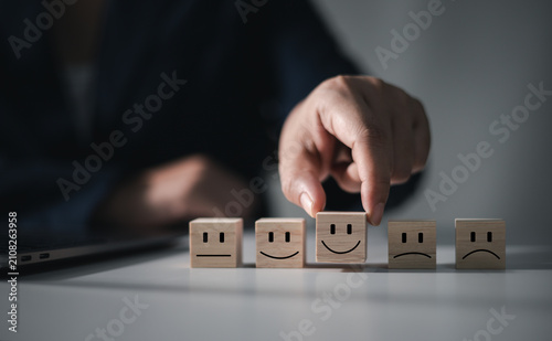 The concept of online reviews and service satisfaction involves digitally displaying customer opinions and ratings on a wooden blog.