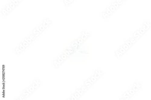 Small white lens flare with subtle radial rays isolated on transparent background