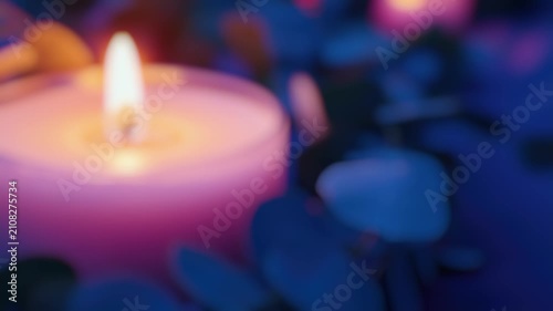 A close-up shot of a lit candle surrounded by leaves, perfect for use in  about nature, cozy atmosphere or warm lighting
