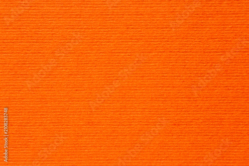 Foto pumpkin orange color backdrop: close up of striped craft paper