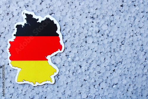 Germany Map with National Flag Symbol on Blue Textured Background with Copy Space