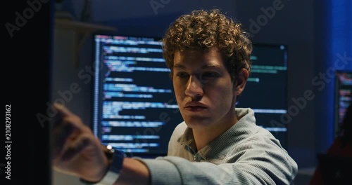 Latin engineer analyzes logs inspects system performance codes fixes and collaborates with colleagues to deliver resilient technology solutions during late hours.