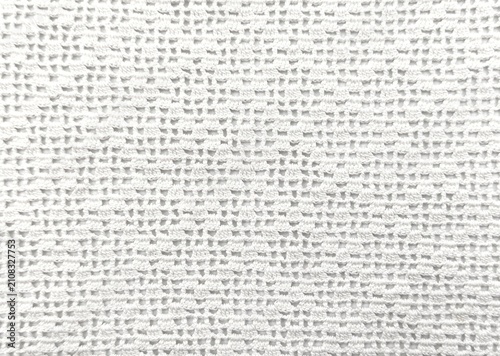 Background view of an elegant white vintage crochet lace textile with intricate handmade needlework, a full frame background texture.