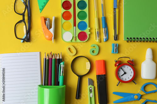Colorful school supplies flat lay on colored chalkboard with notepad, pencil, ruler and September tag, perfect for education, learning and classroom design.