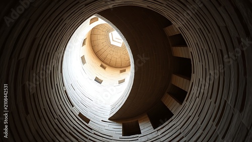 Interior of a round stone tower, corner where masonry walls curve inward to support the ceiling.