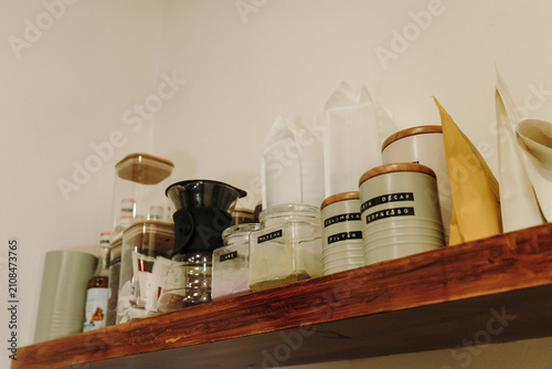Bild auf Leinwand Organized coffee station shelf with brewing equipment, storage containers and coffee supplies