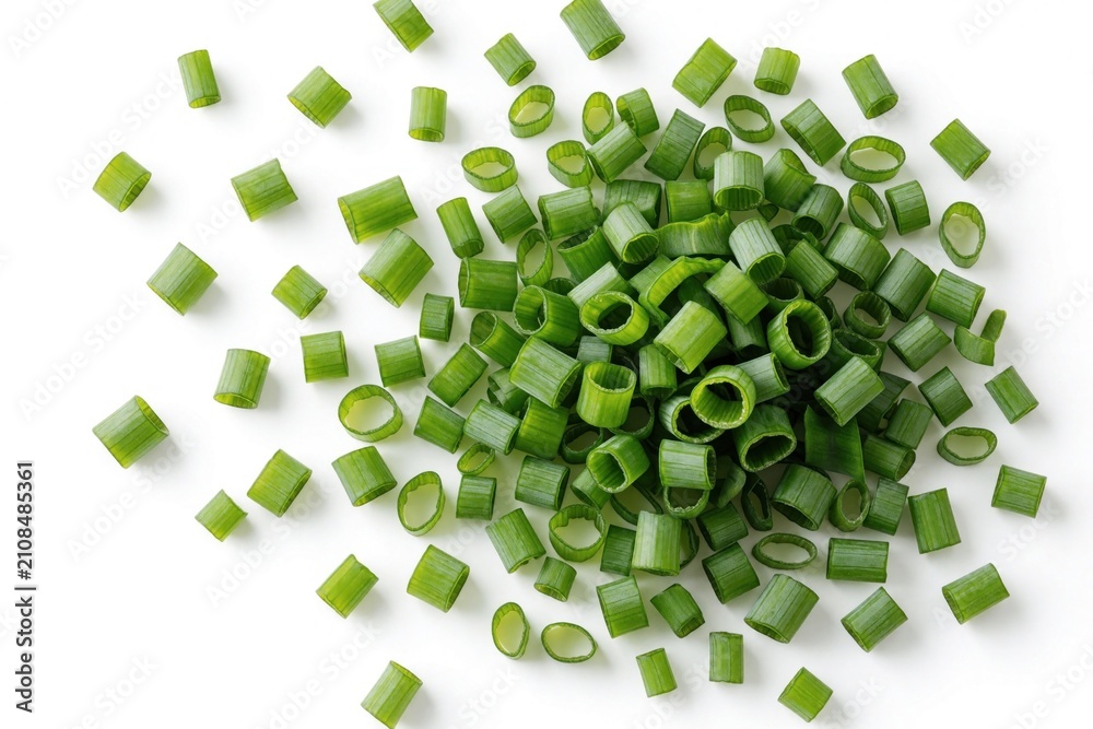 Obraz premium Pile of chopped green onion isolated on white background. Small fresh chives pieces scattered around central mound. Raw healthy vegetable herb cut for food cooking recipe. Flat top view organic