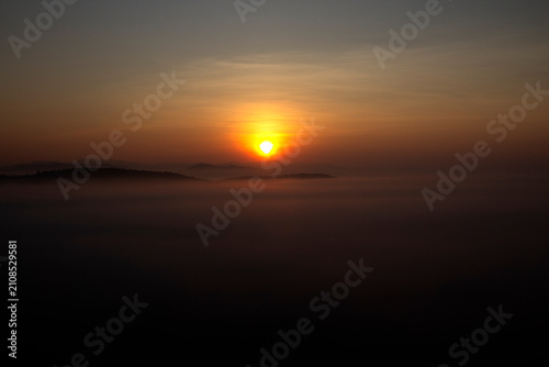 The morning sun rising through the clouds.